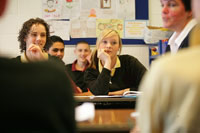 Pupils in a classroom listening to a teacher