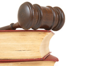 Gavel with book on white background.