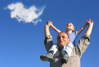 A man with a child on his shoulders, both reaching for the sky.